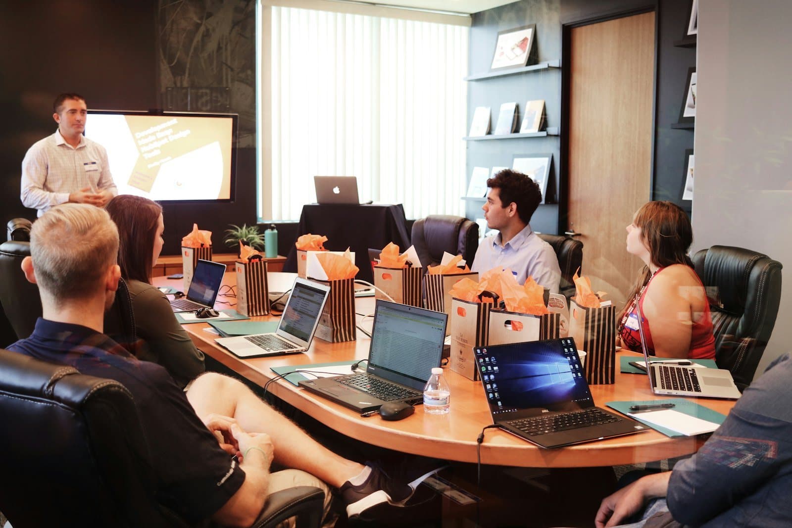 The underwriting team in a meeting room with laptops open